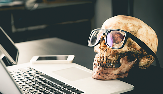 skull with glasses on a desk for halloween