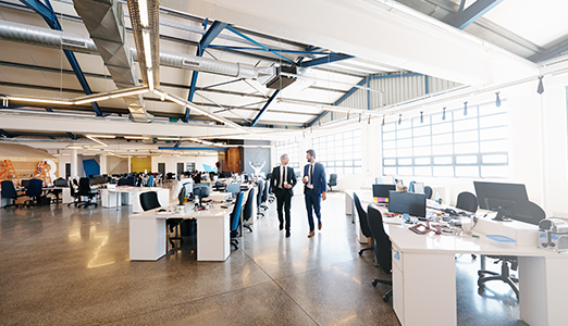 two men walking in an office