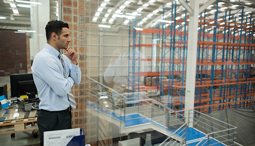 man overlooking manufacturing floor